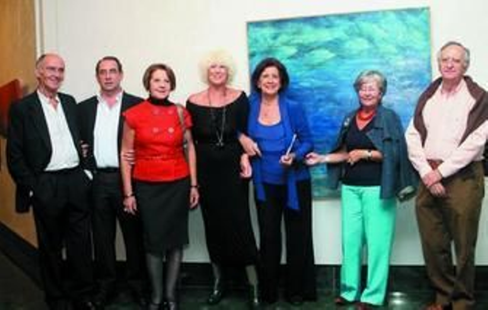 Bernarda Morales, junto a unos amigos, posa delante de una marina.