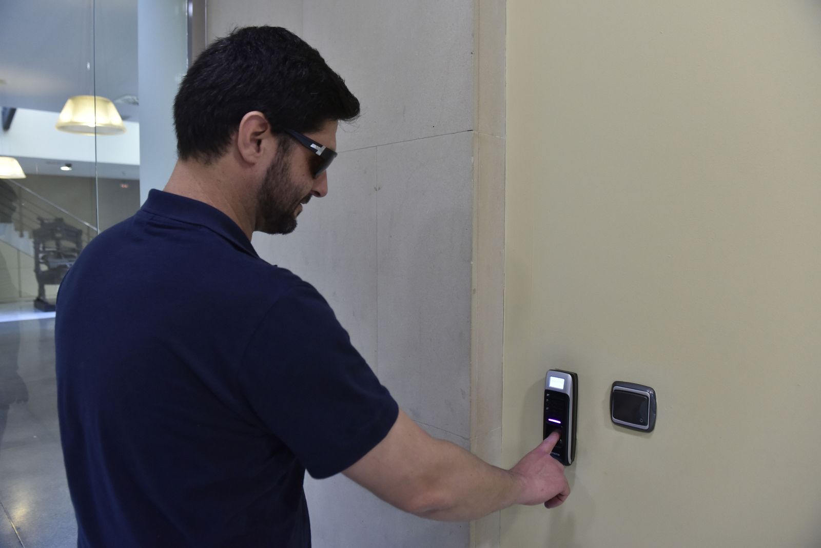 Un trabajador ficha en el control horario.