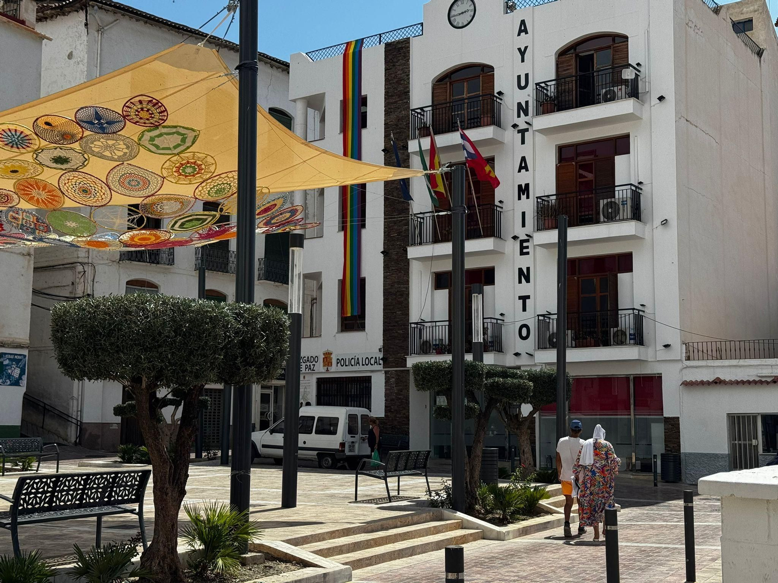 Dos personas caminan hacia el Ayuntamiento de Albuñol