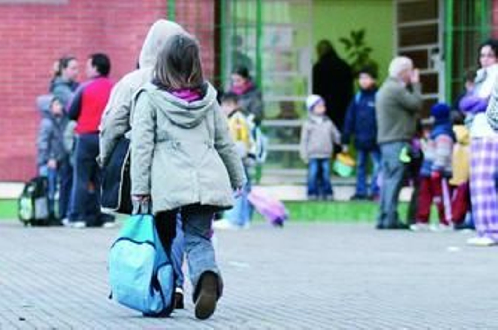 Unos escolares entran a un centro educativo.