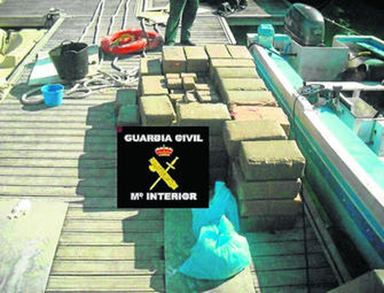 La droga y la embarcación, a la derecha, intervenidas.
