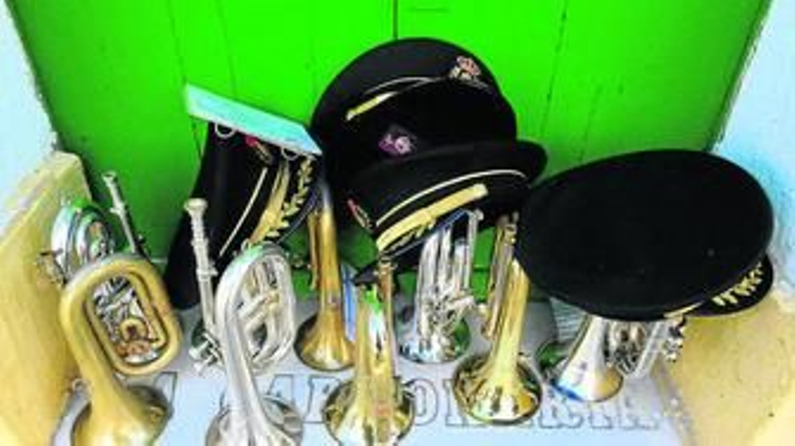Gorras e instrumentos aguardan en un escalón al comienzo del certamen en la plaza de San José.