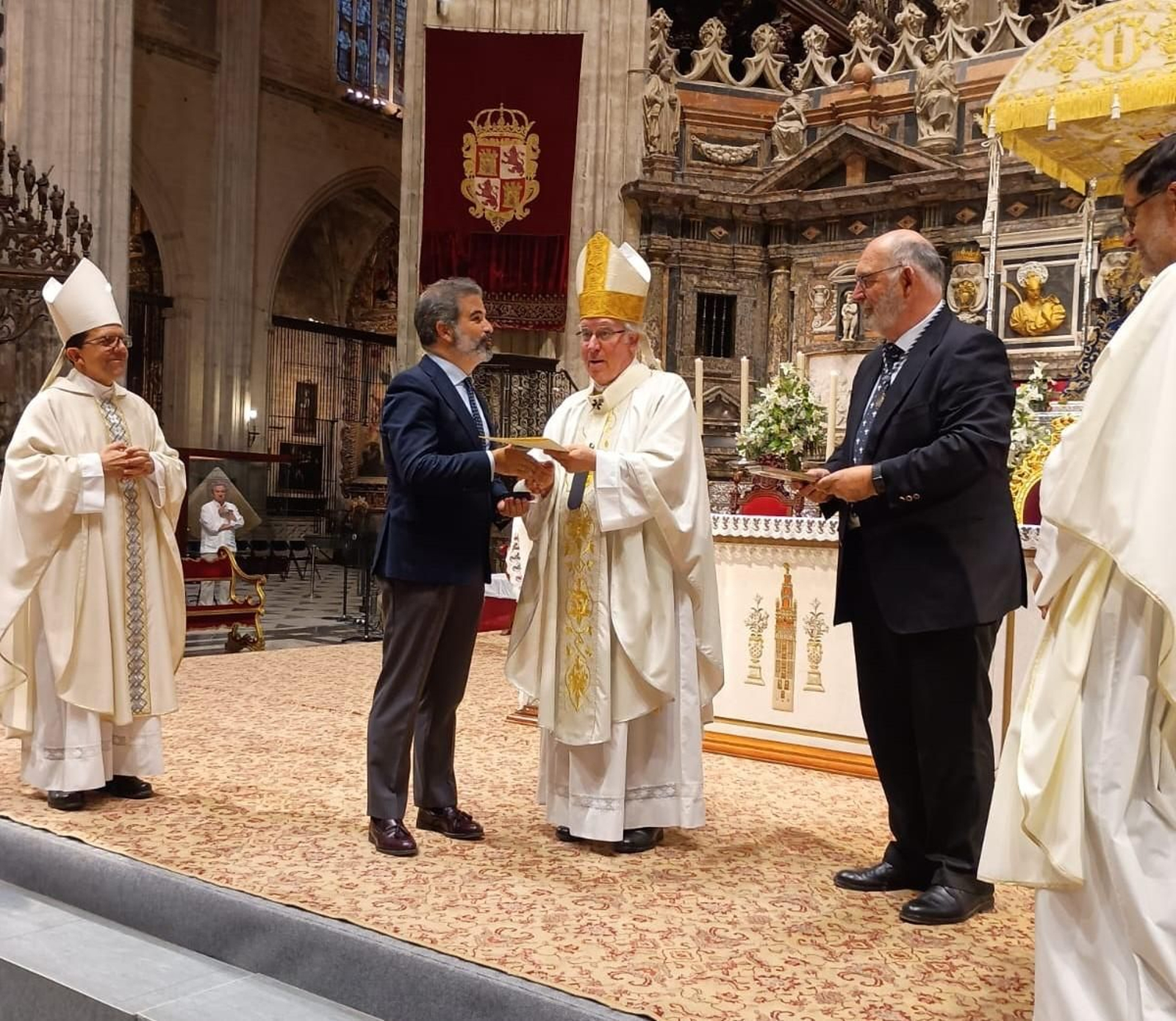El arzobispo de Sevilla, monseñor José Ángel Saiz, entrega la medalla de la Virgen de los Reyes a la Hermandad de Jesús Nazareno, de La Algaba.