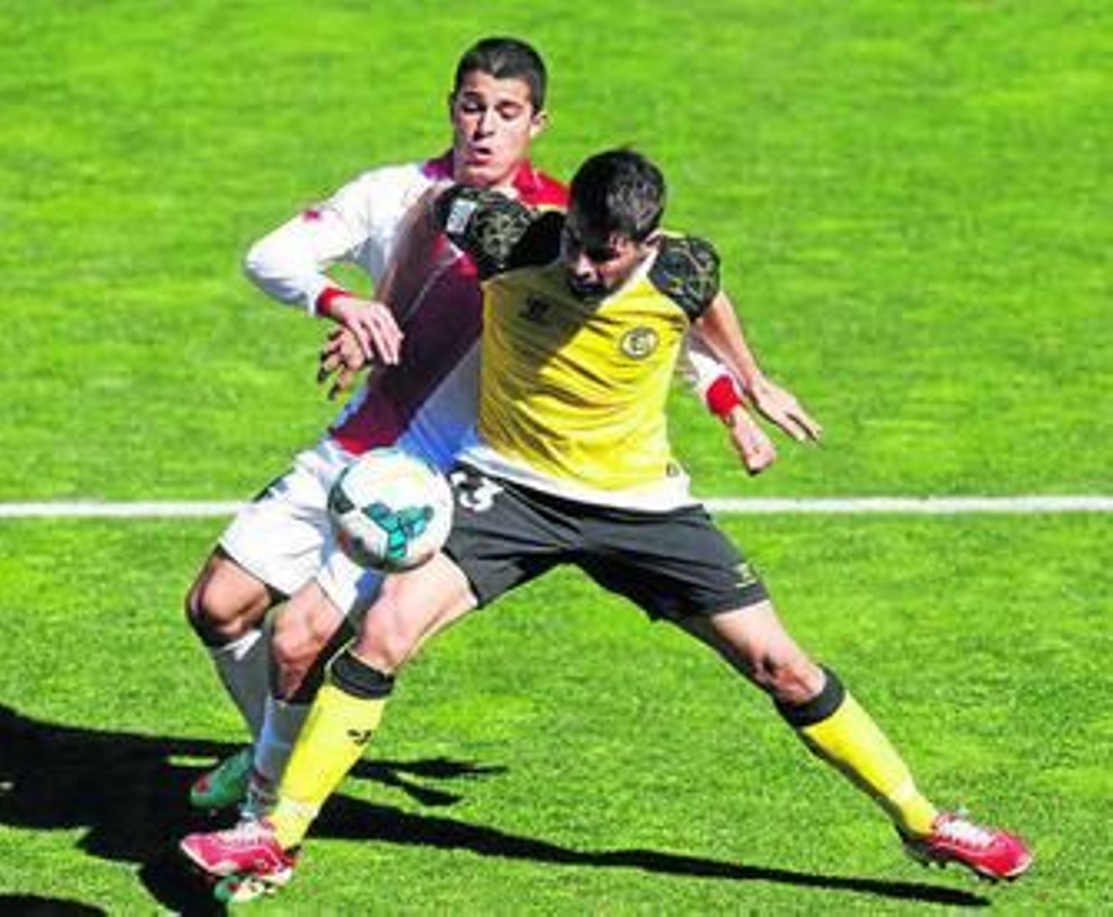 Coke defiende la posesión de la pelota ante Iago Falqué.