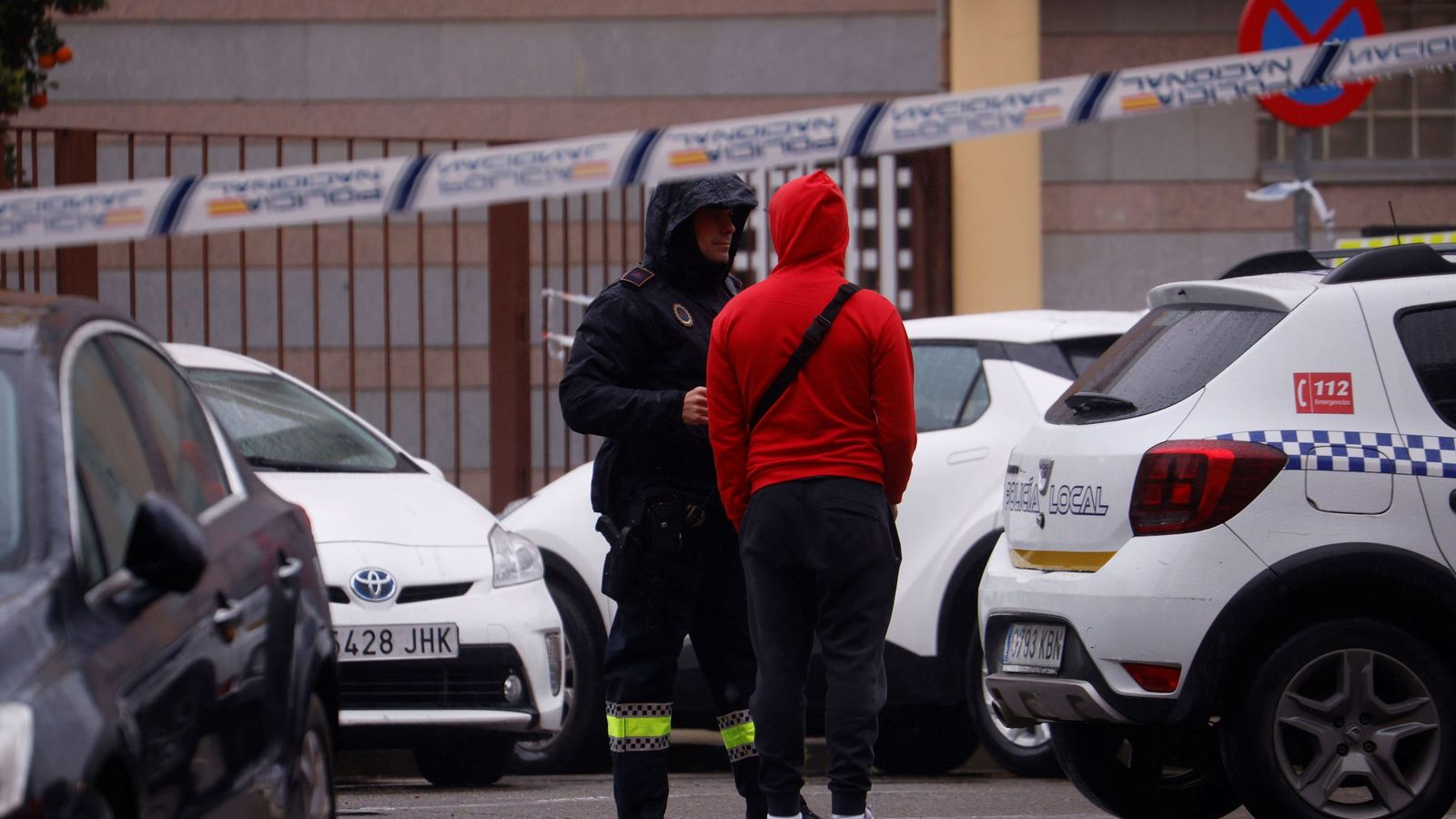 Un familiar de las víctimas de Adamuz conversa con un agente de la Policía Nacional.