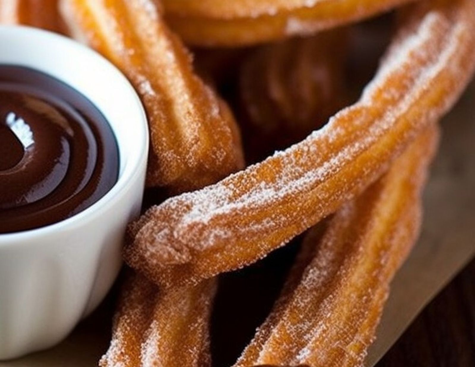 Un plato de churros con chocolate para mojar
