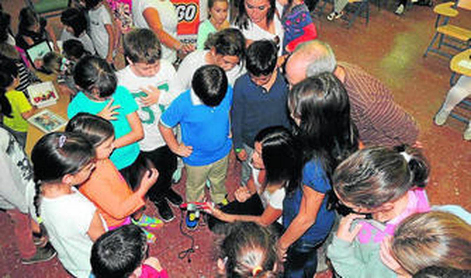 Los alumnos del centro escolar observan las evoliciones de un robot durante el taller.