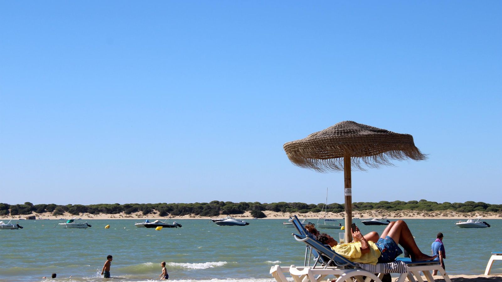 Adultos y pequeños disfrutando de la playa de Sanlúcar.