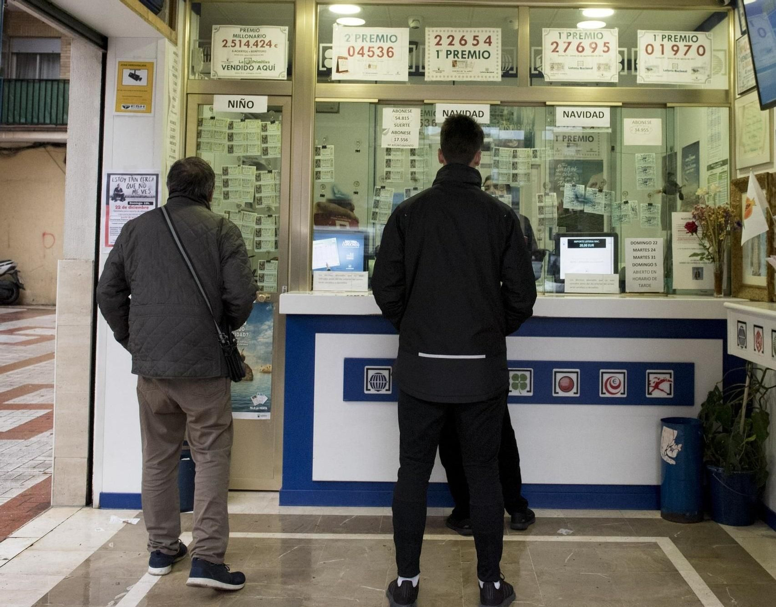 Varias personas en una administración de lotería.