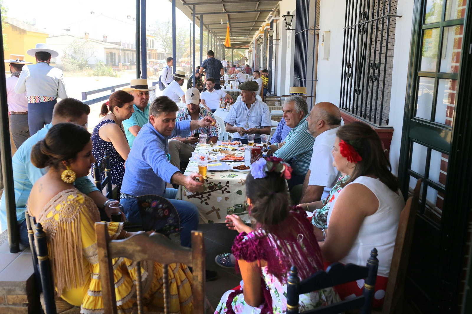 Un grupo de rocieros disfruta del mediodía en el porche de una casa. Un grupo de rocieros disfruta del mediodía en el porche de una casa.