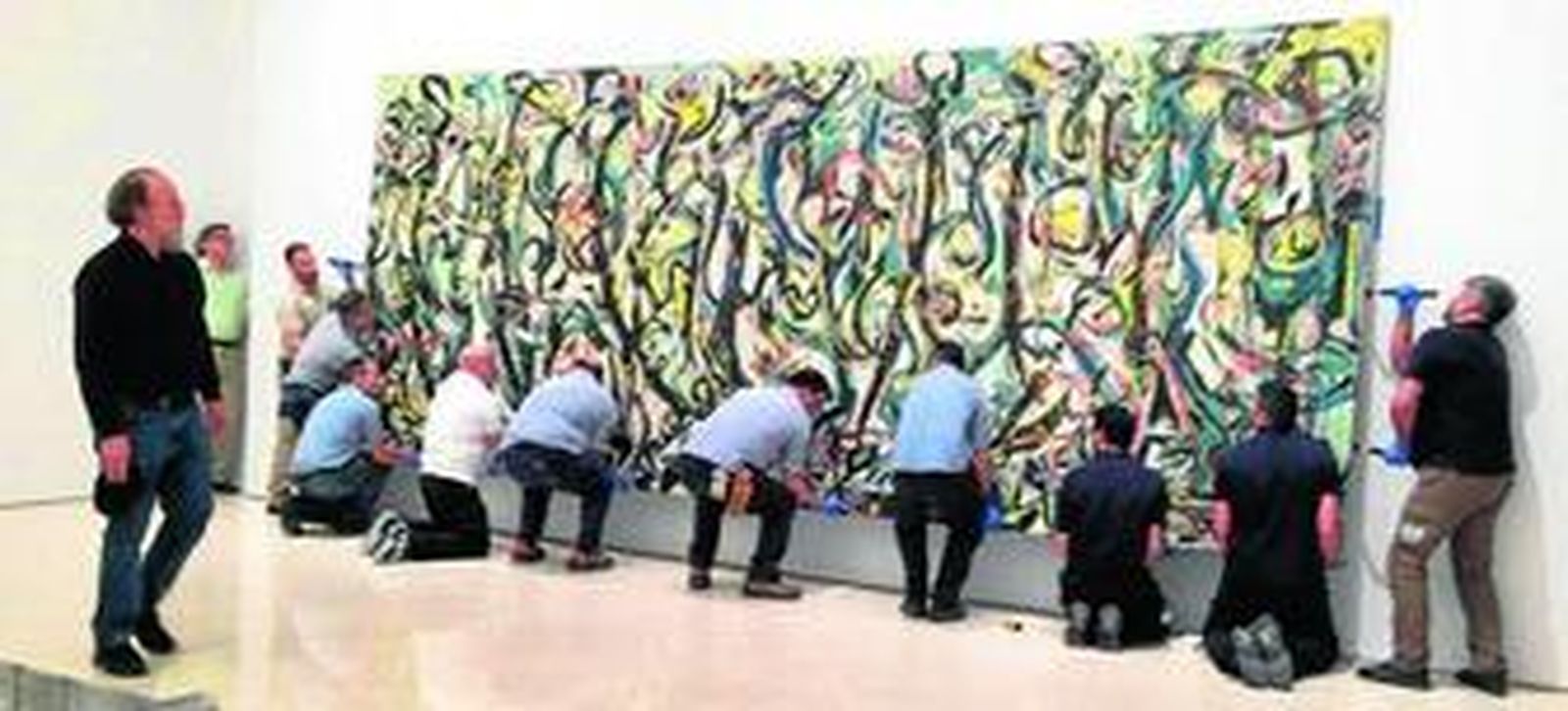 Parte del equipo coloca el 'Mural' en el Museo Picasso Málaga.