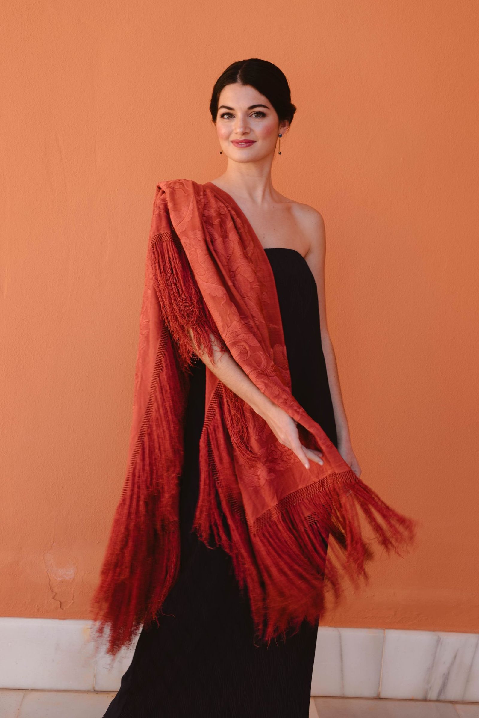 El mantón de Manila se convierte en el complemento perfecto para darle a look de invitada el punto elegante.