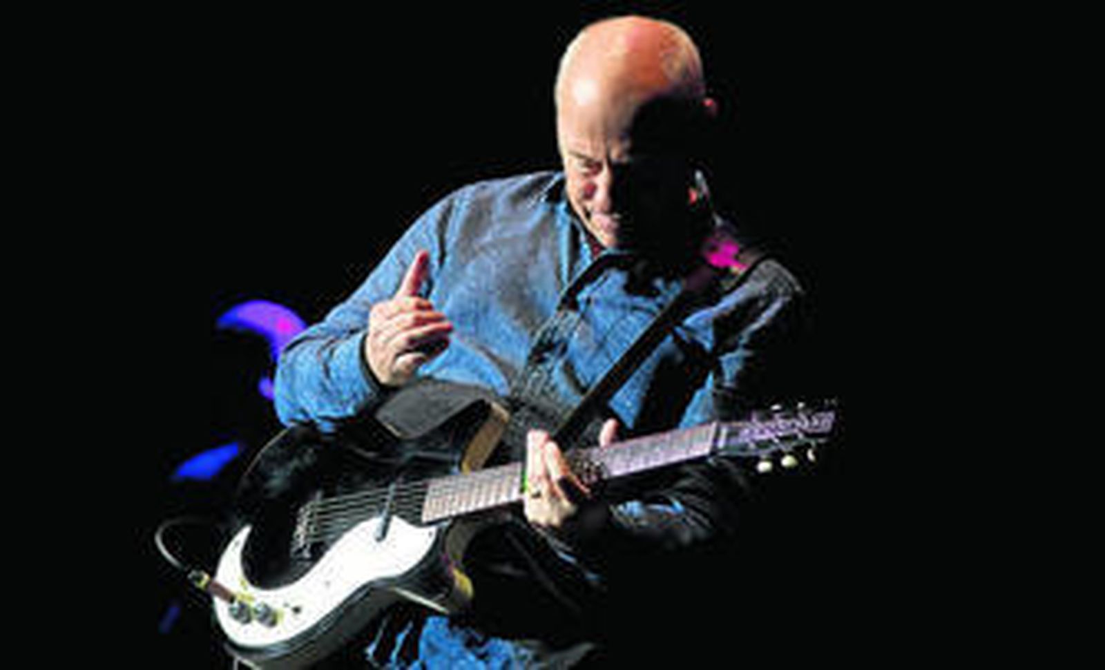 Mark Knopfler, durante una actuación ofrecida en Málaga en el verano de 2013.