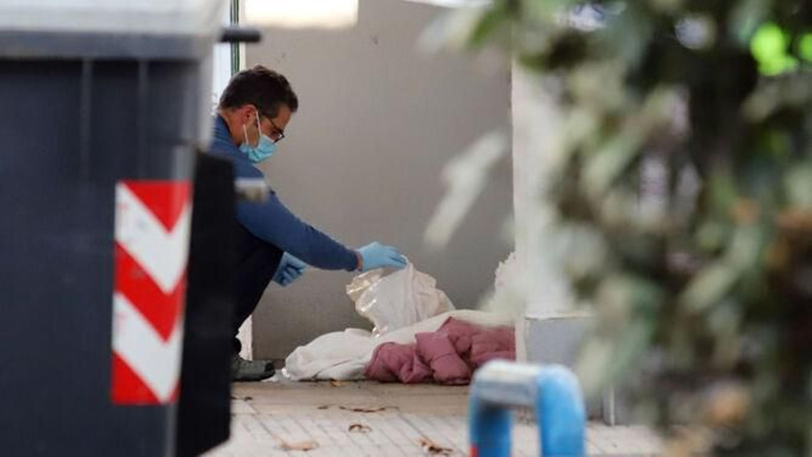 Un agente inspecciona la bolsa donde se encontraba la cabeza.