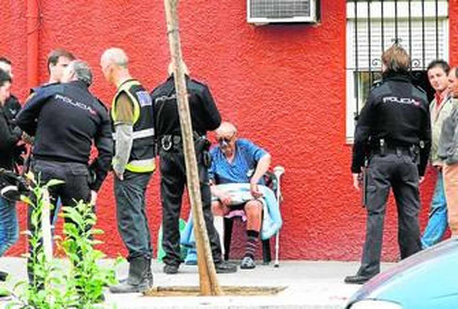 Policías nacionales en la puerta de la vivienda calcinada, ayer por la mañana.
