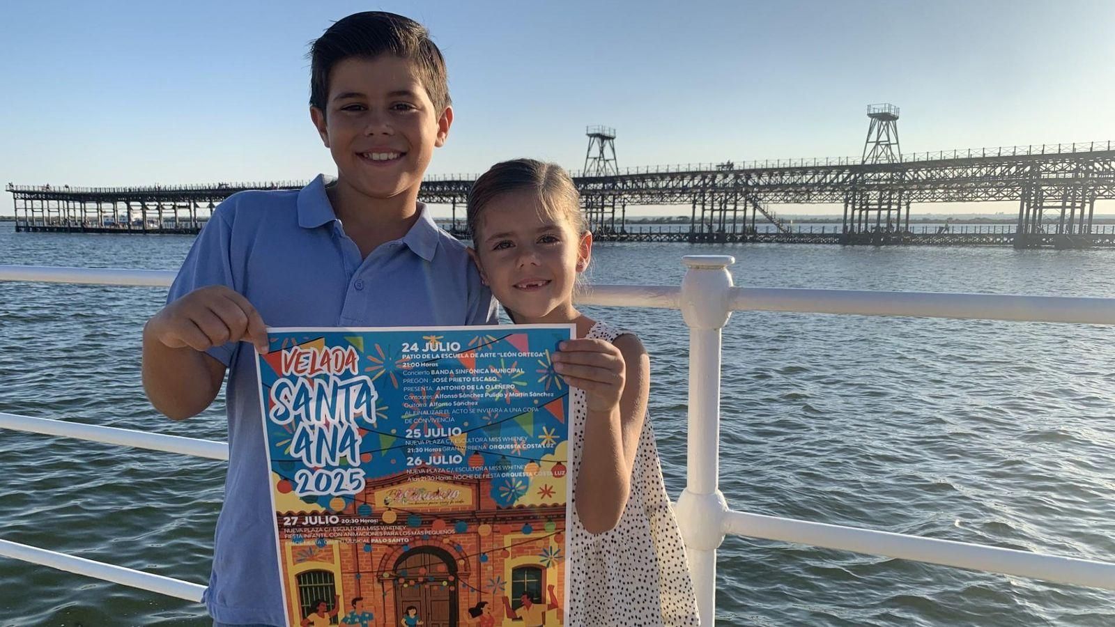 Dos niños muestran el cartel de la Velada.