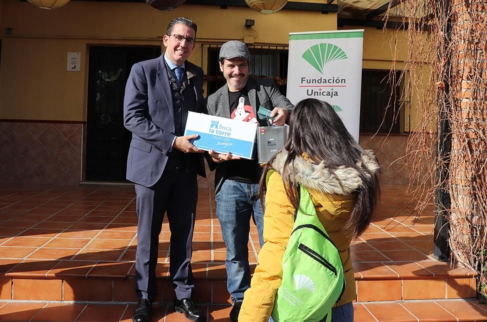 El director general de la Fundación Unicaja, Sergio Corral (izquierda), y el chef Sergio Garrido repartiendo los regalos.