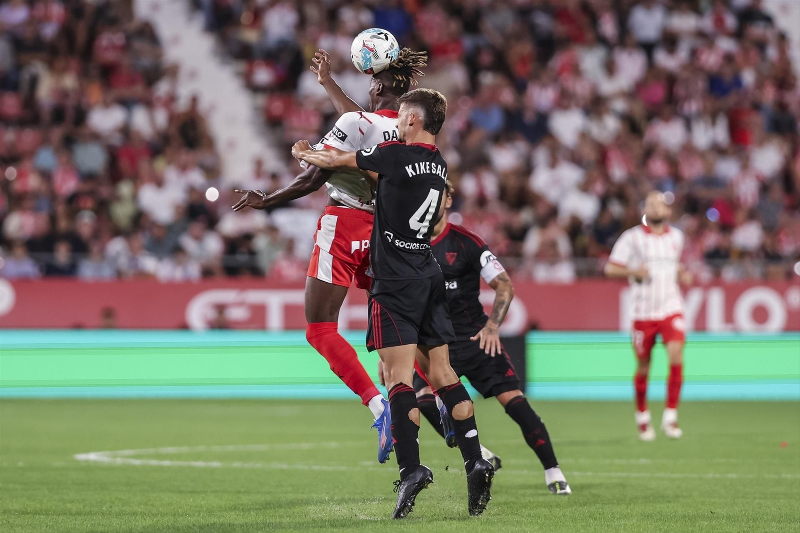 Kike Salas salta con Dawda en el tramo final del encuentro.