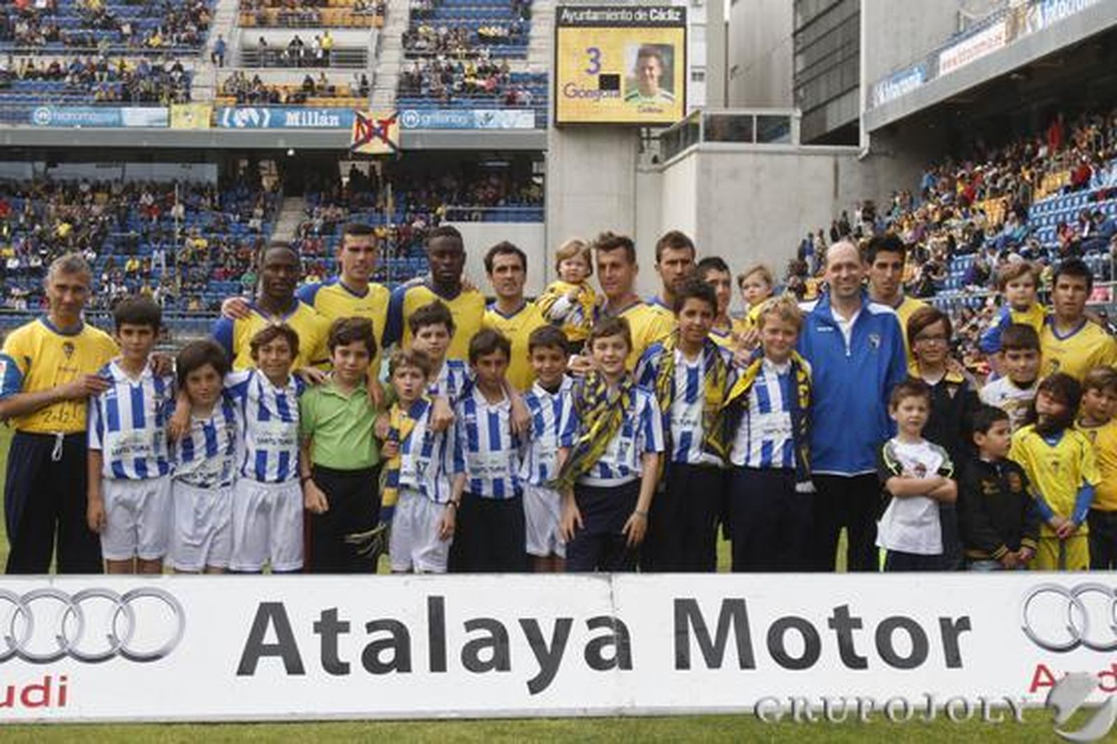 El once del Cádiz, rodeado de niños. 

Foto: Lourdes de Vicente