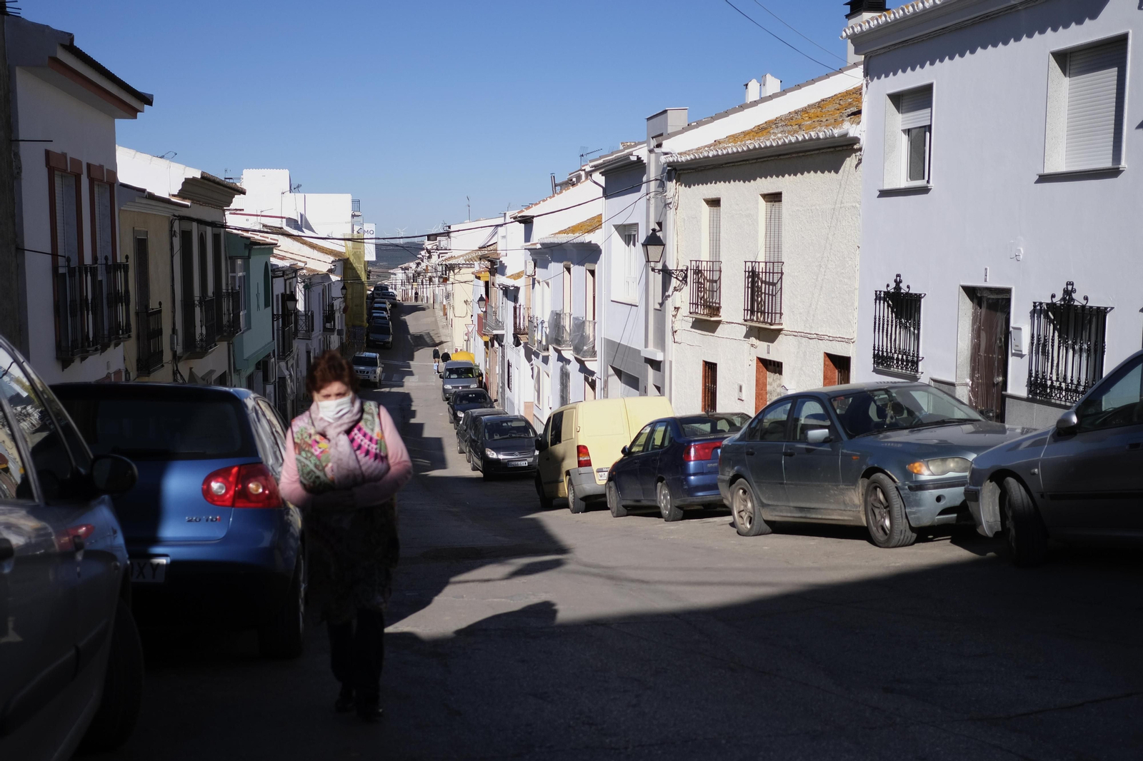 Una vecina camina por una solitaria calle en Teba