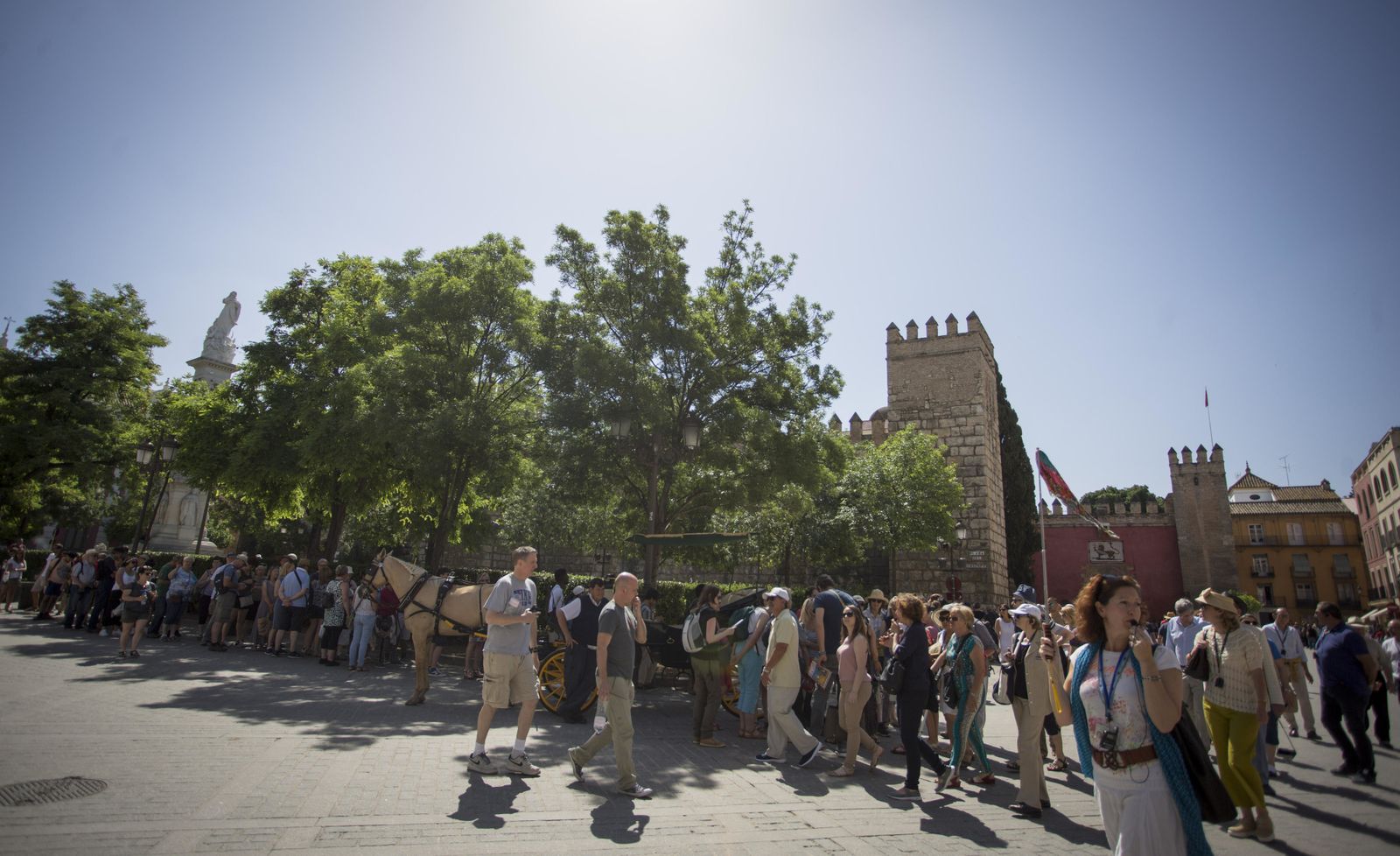 Largas colas de turistas esperan para acceder al Alcázar.