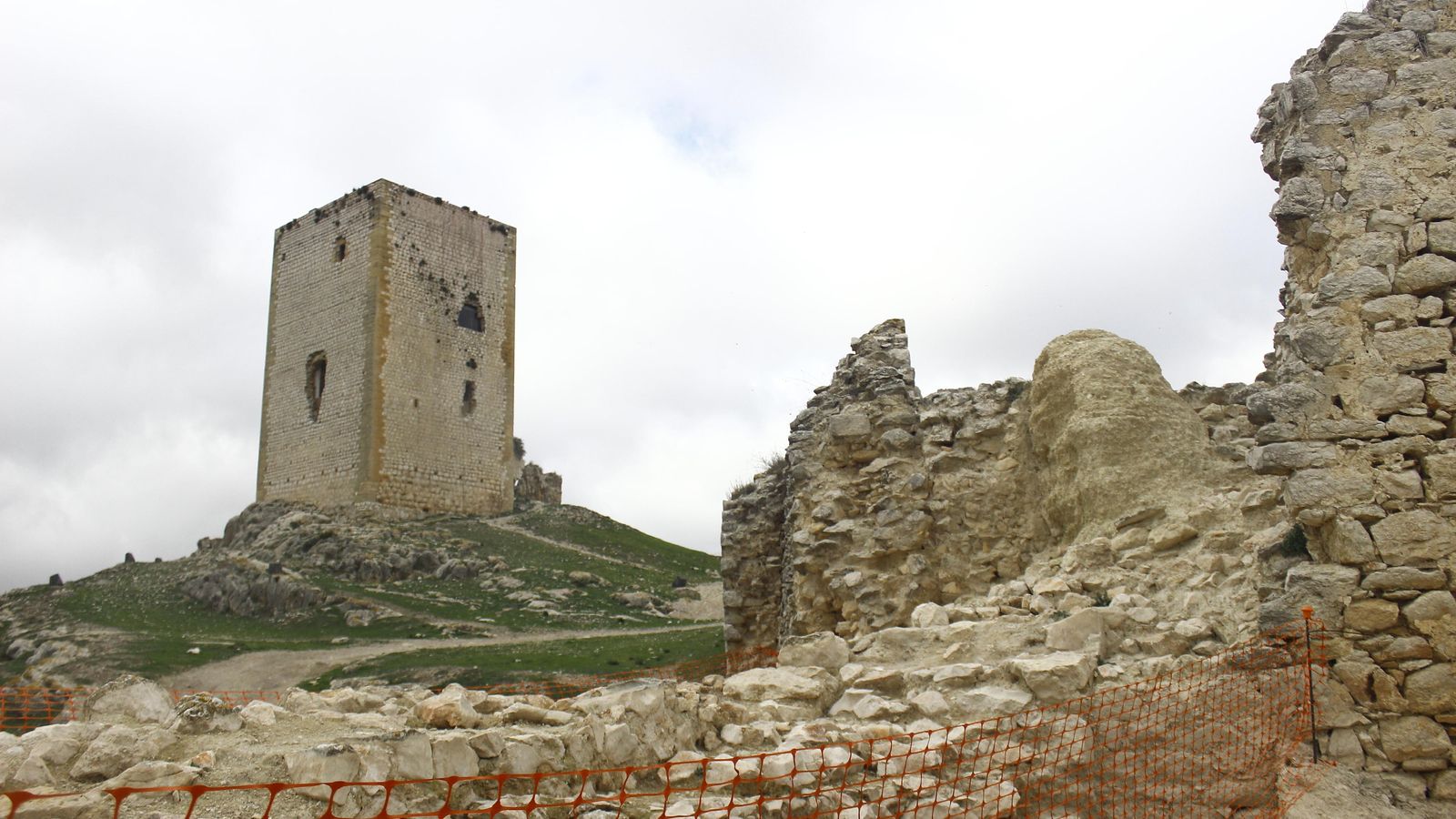 Parte de los trabajos en un muro, con la Torre del Homenaje detrás.