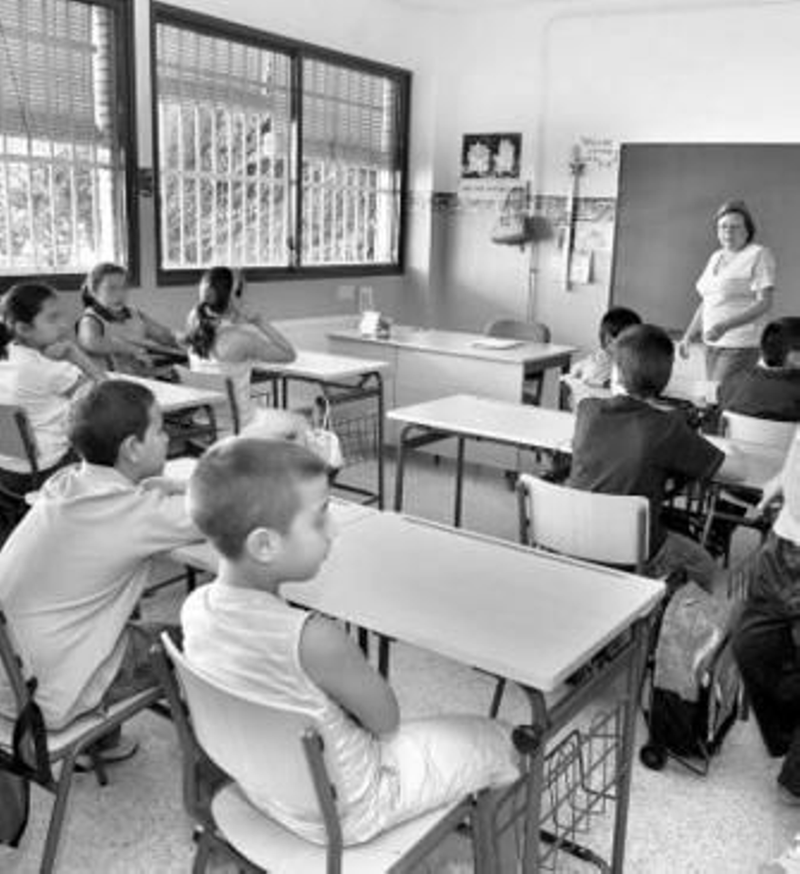 Un grupo de alumnos sigue las explicaciones de su profesora.