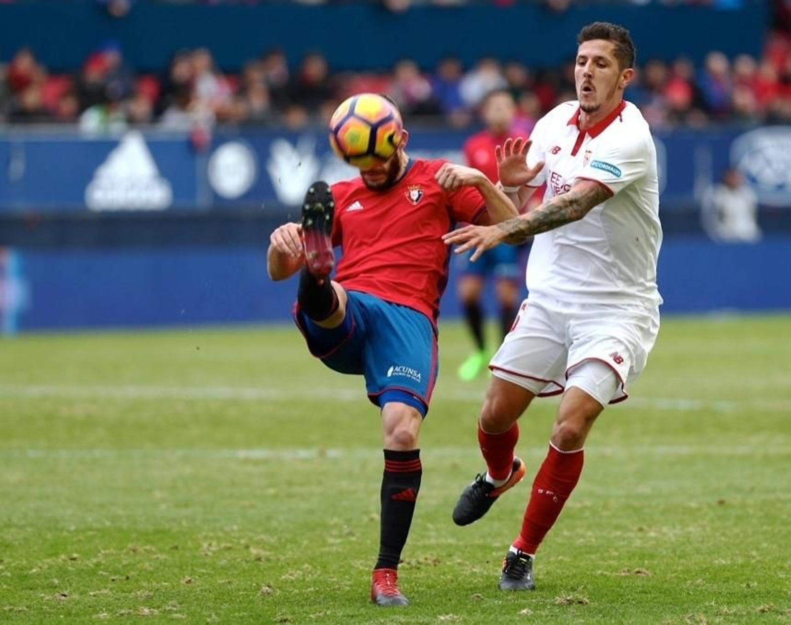 Roberto Torres intenta despejar un balón que perseguía el montenegrino Jovetic sobre el pésimo césped de El Sadar.