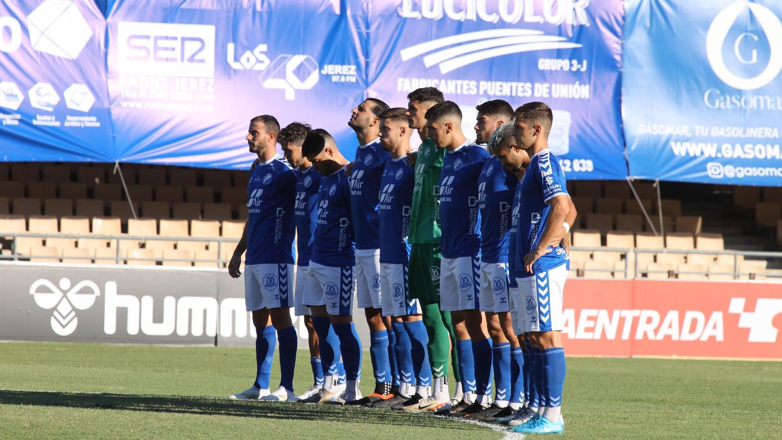 Los jugadores del Xerez DFC guardan un minuto de silencio en Chapín ante el Torremolinos.