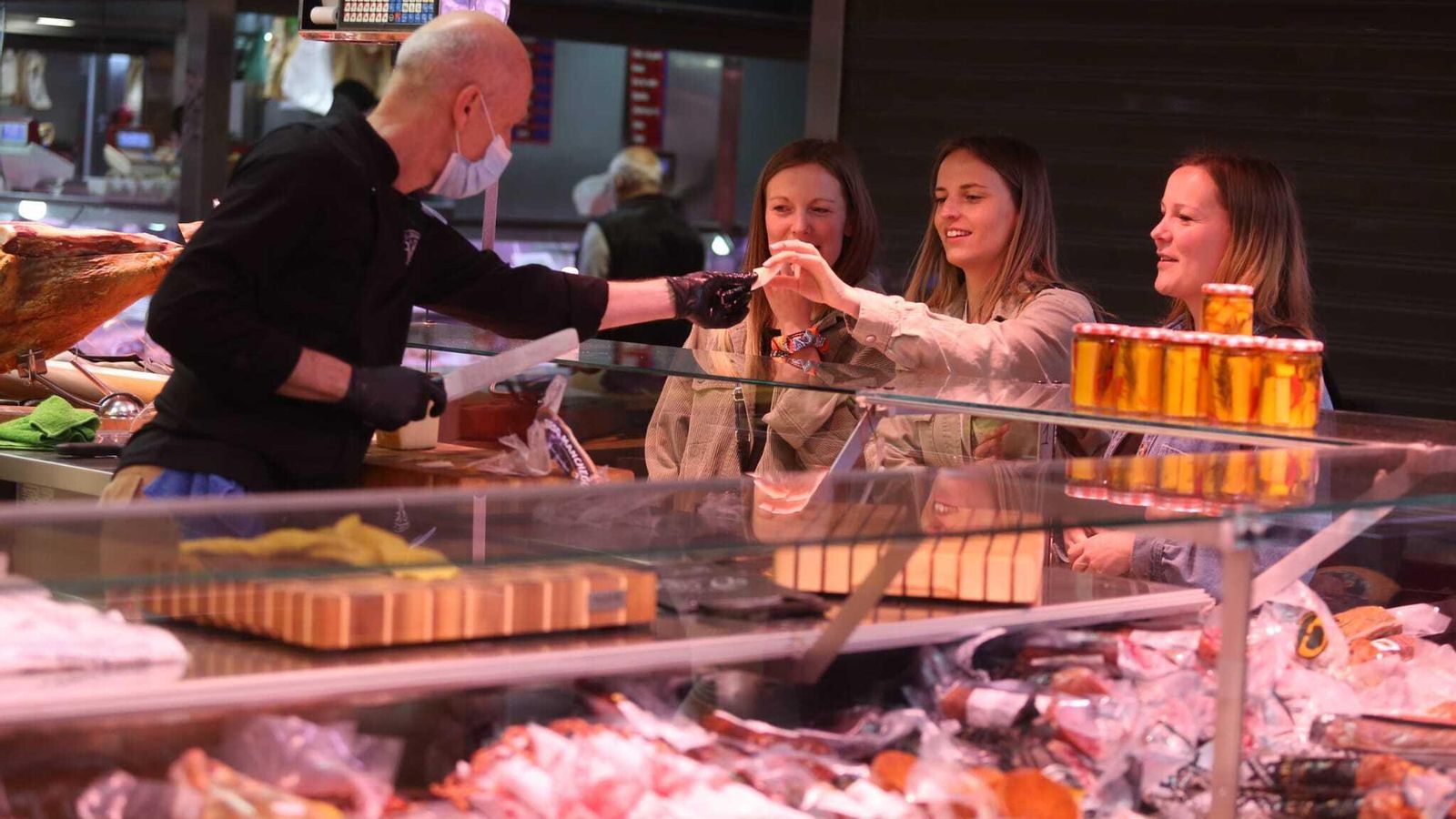 Tres mujeres, en un puesto del mercado de Atarazanas.