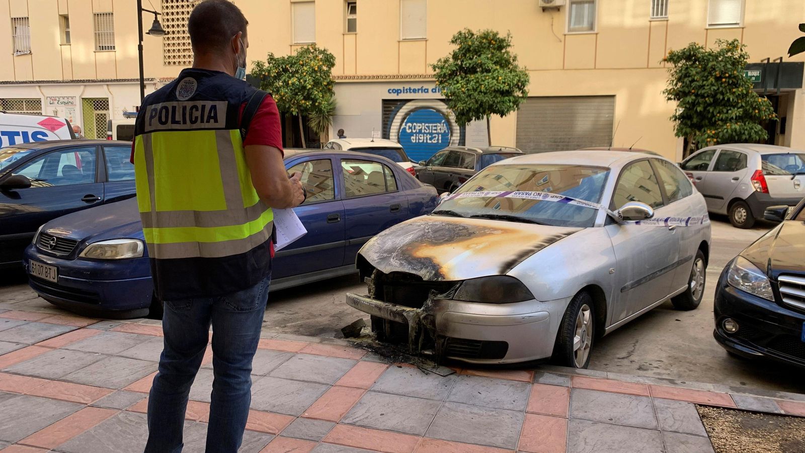 Un policía junto a uno de los vehículos siniestrados.