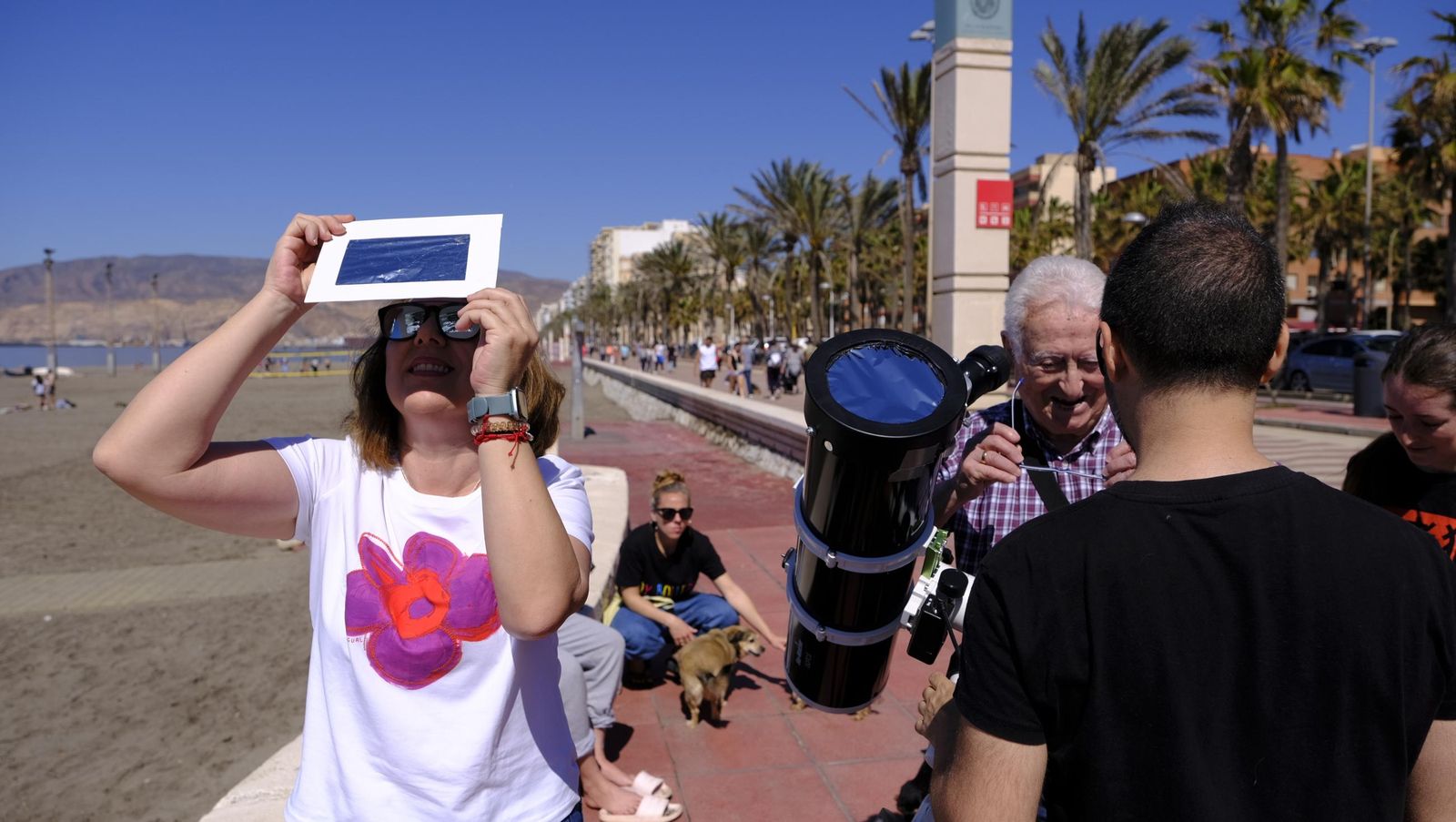 Almería observa el eclipse solar desde el Paseo Marítimo, en imágenes