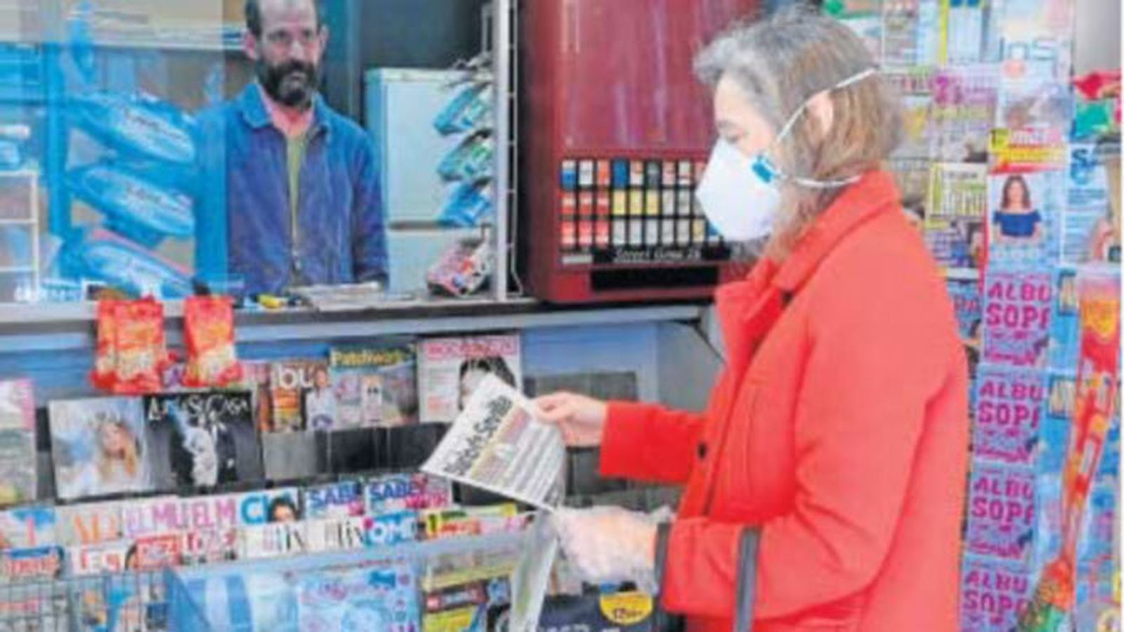 Una mujer compra en un quiosco el 'Diario de Sevilla'