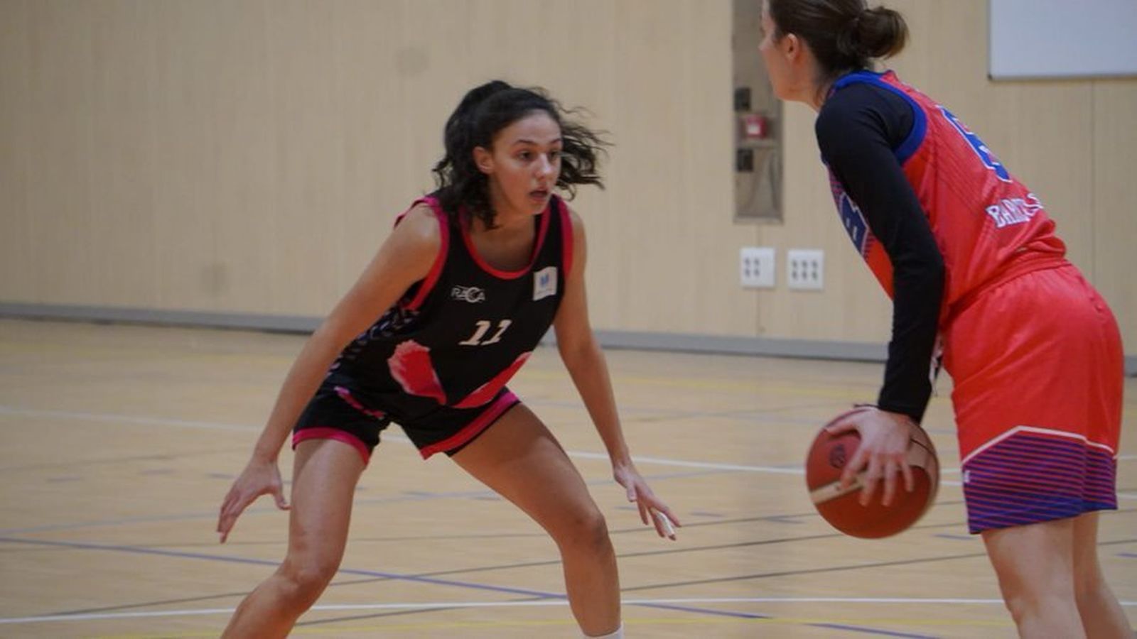 Marina Gea defiende a una jugadora rival.