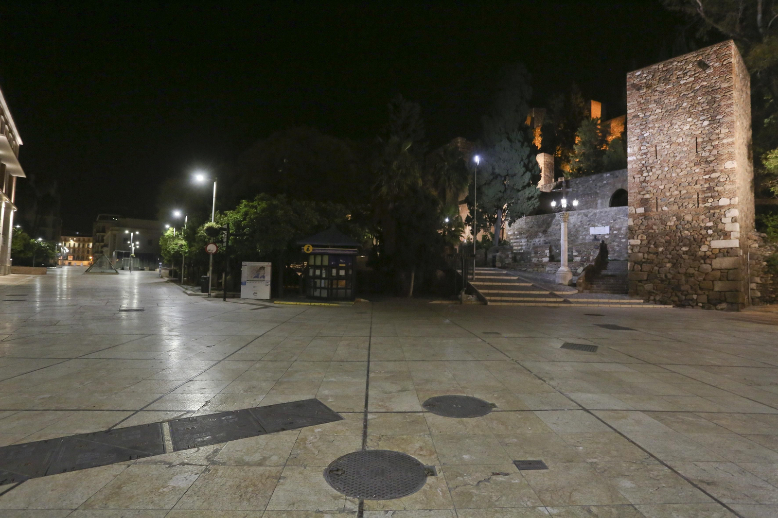 El coronavirus dibuja una noche desierta en el centro de Málaga, en fotos
