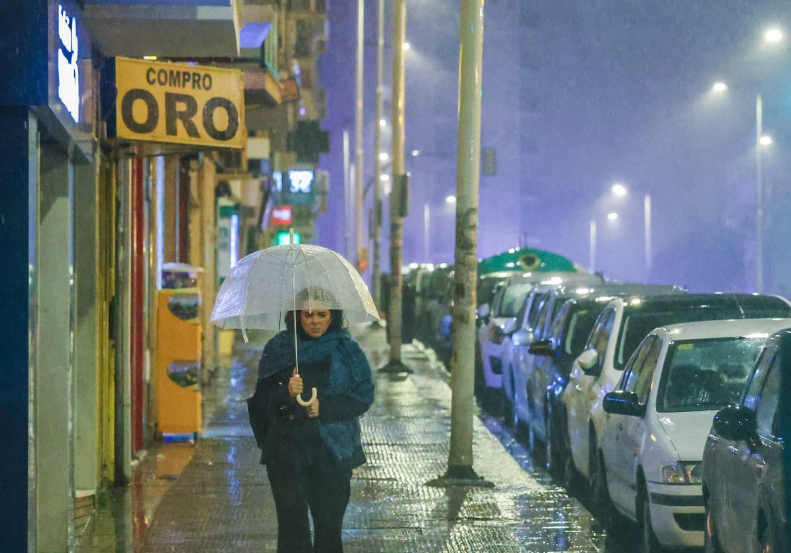 Una señora bajo la lluvia este miércoles en Huelva.