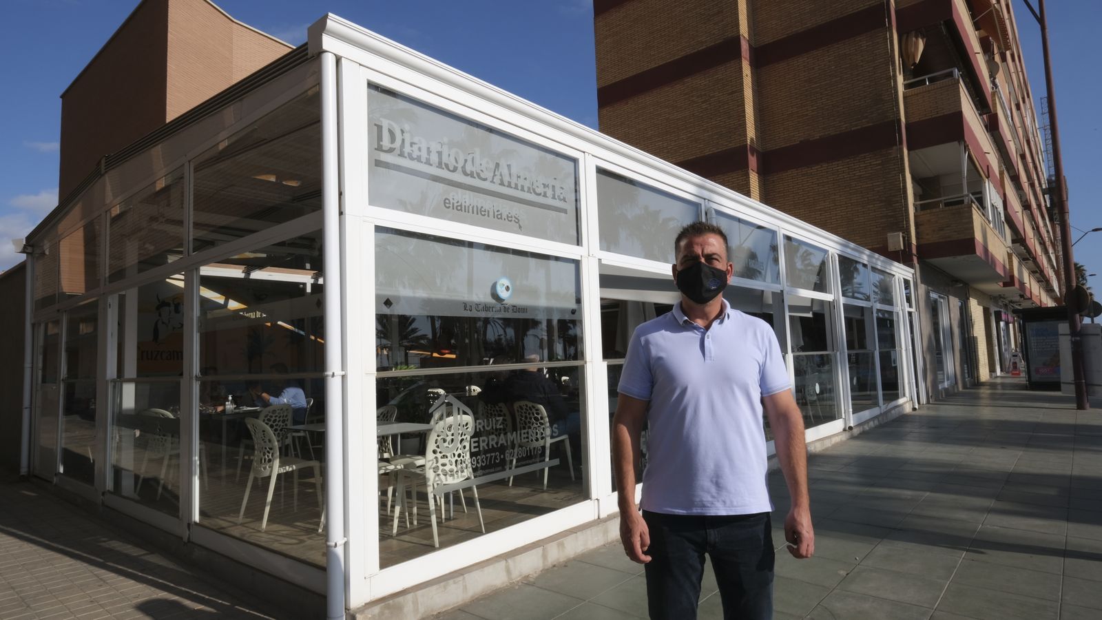 El gerente de este negocio junto a la terraza de su establecimiento.