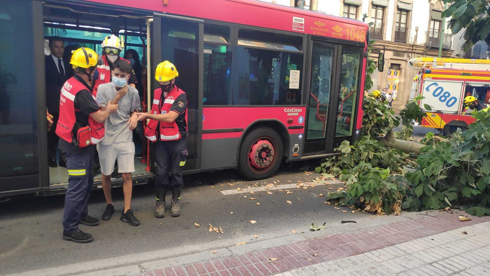 Los bomberos atienden a unos de los pasajeros del autobús