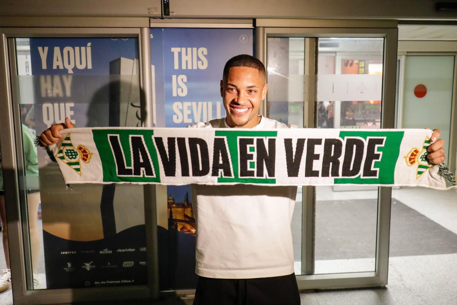 Vitor Roque posa con la bufanda del Betis en el aeropuerto de San Pablo.