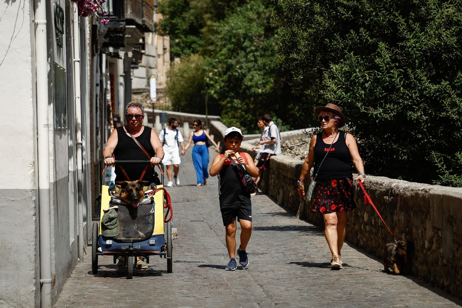 Paraguas, abanicos y agua: las mejores imágenes de la primera ola de calor de agosto en Granada