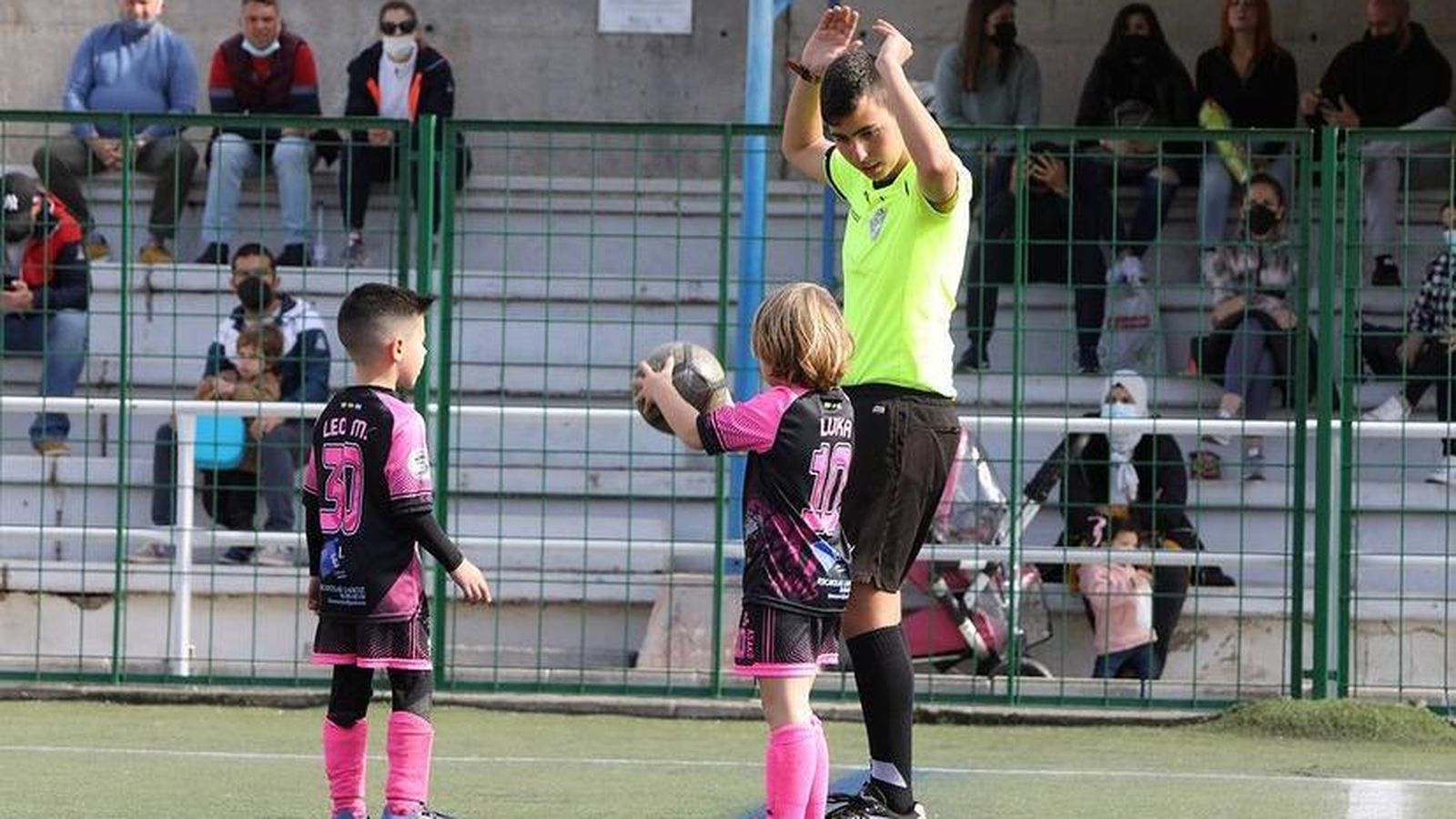 El joven árbitro explica a los jugadores cómo realizar un saque.