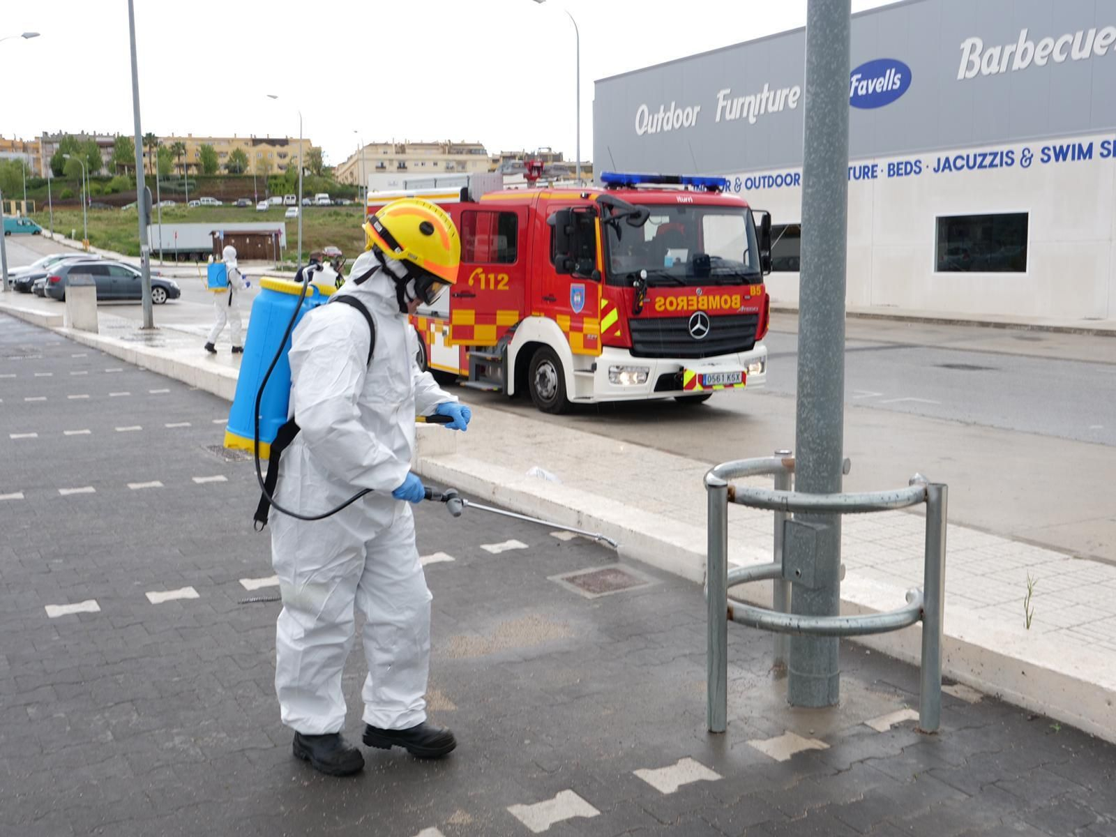 Un efectivo del Cuerpo de Bomberos de Mijas desinfectando una calle.