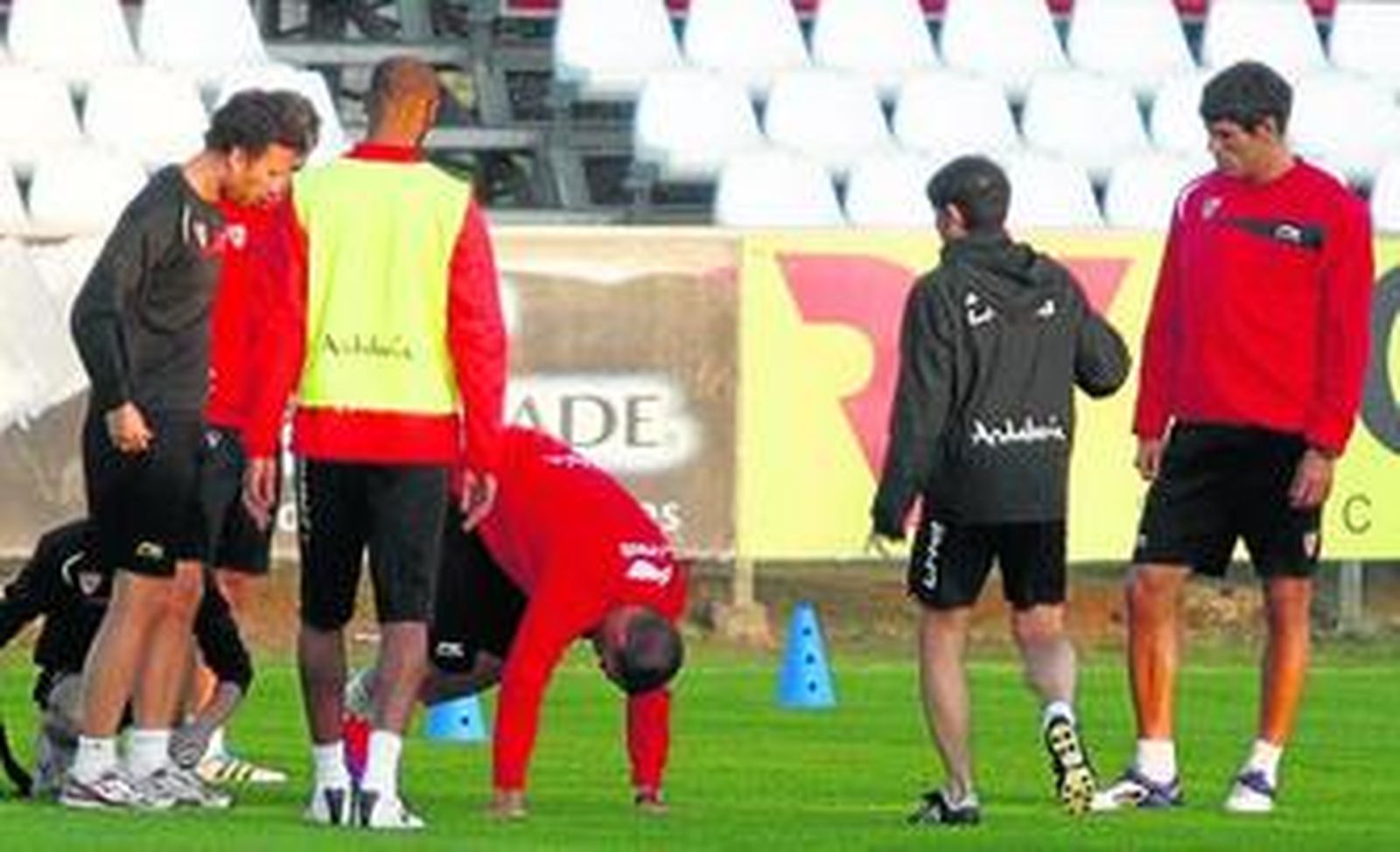 Negredo es atendido por el médico, Juan José Jiménez, ante la mirada de Rakitic y Kanoute, de espaldas. Marcelino y Fazio también están atentos.