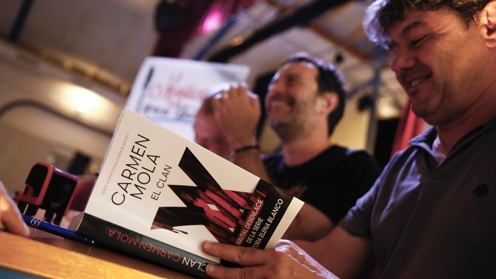 Los escritores Carmen Mola durante la firma de libros.