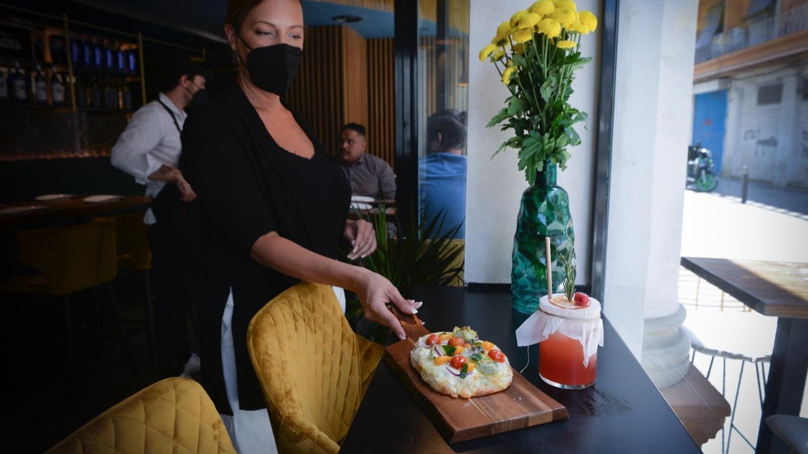 Inma Muñoz sirve una 'pinza' acompañada de un cóctel.