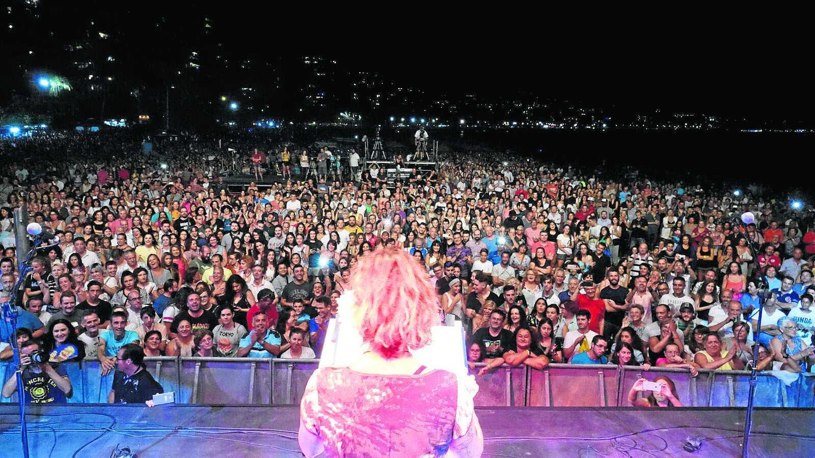 Los asistentes siguen con atención el pregón de la cantante.