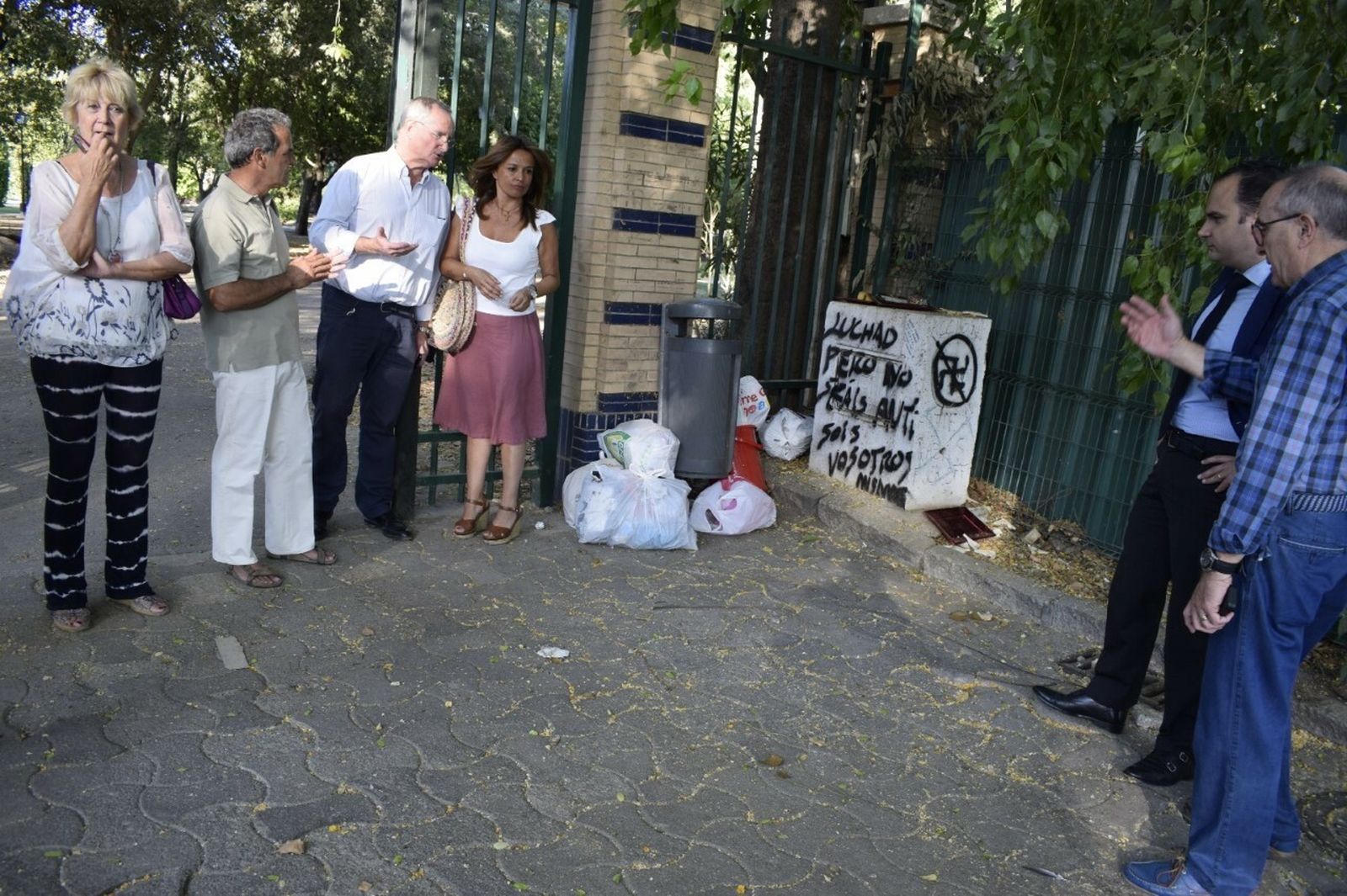 Los concejales del PP comprueban con varios vecinos de Los Remedios la basura acumulada a la entrada del Parque de los Príncipes.