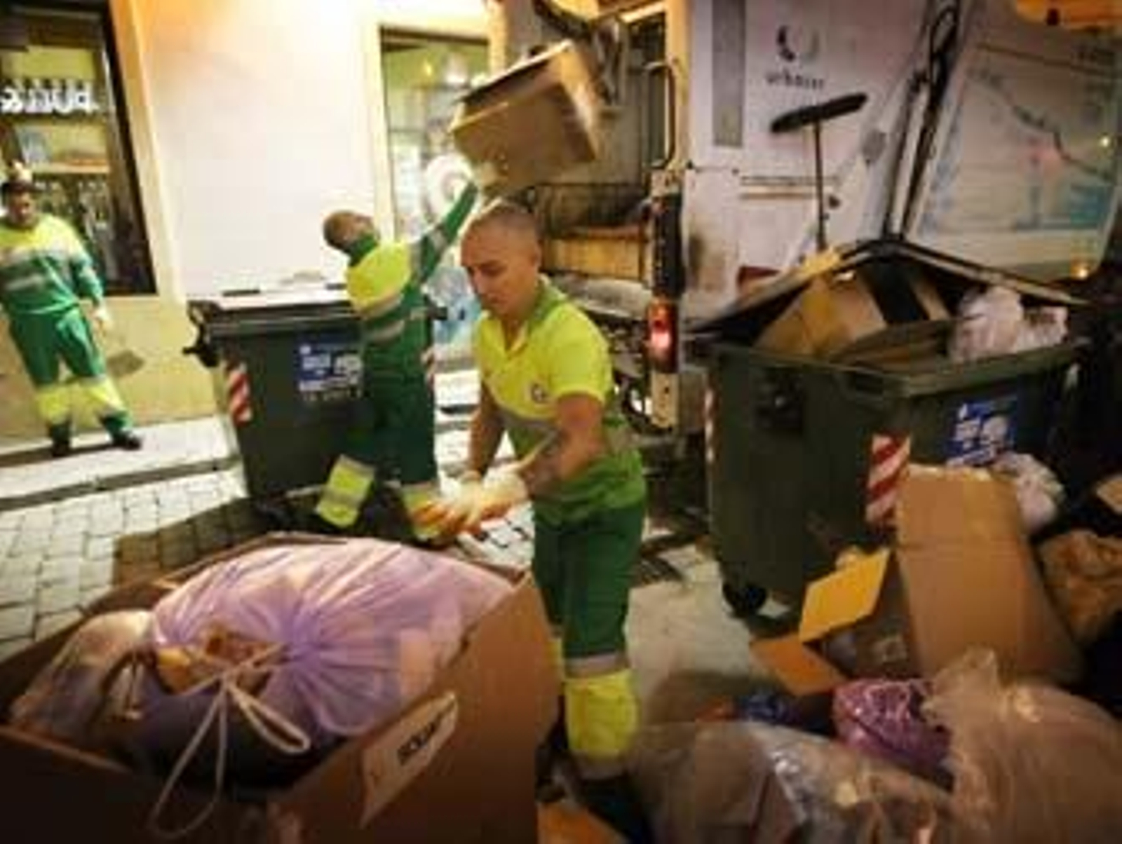 Trabajadores de Urbaser inician anoche la recogida de basuras en el centro de Jerez tras desconvocarse la huelga. /Miguel Ángel González