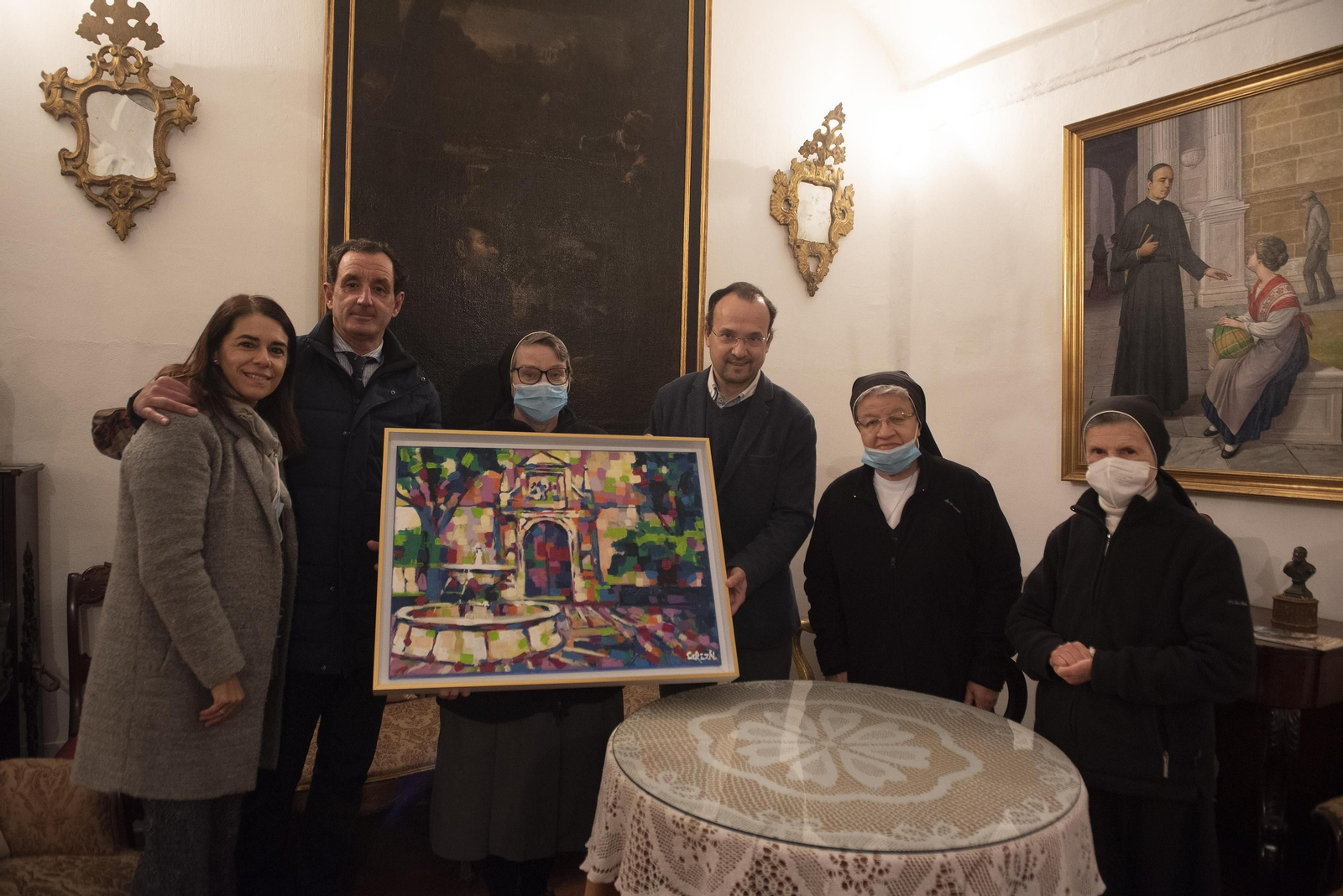 El pintor José Cerezal junto a las religiosas y colaboradores de la comunidad durante la donación del cuadro.