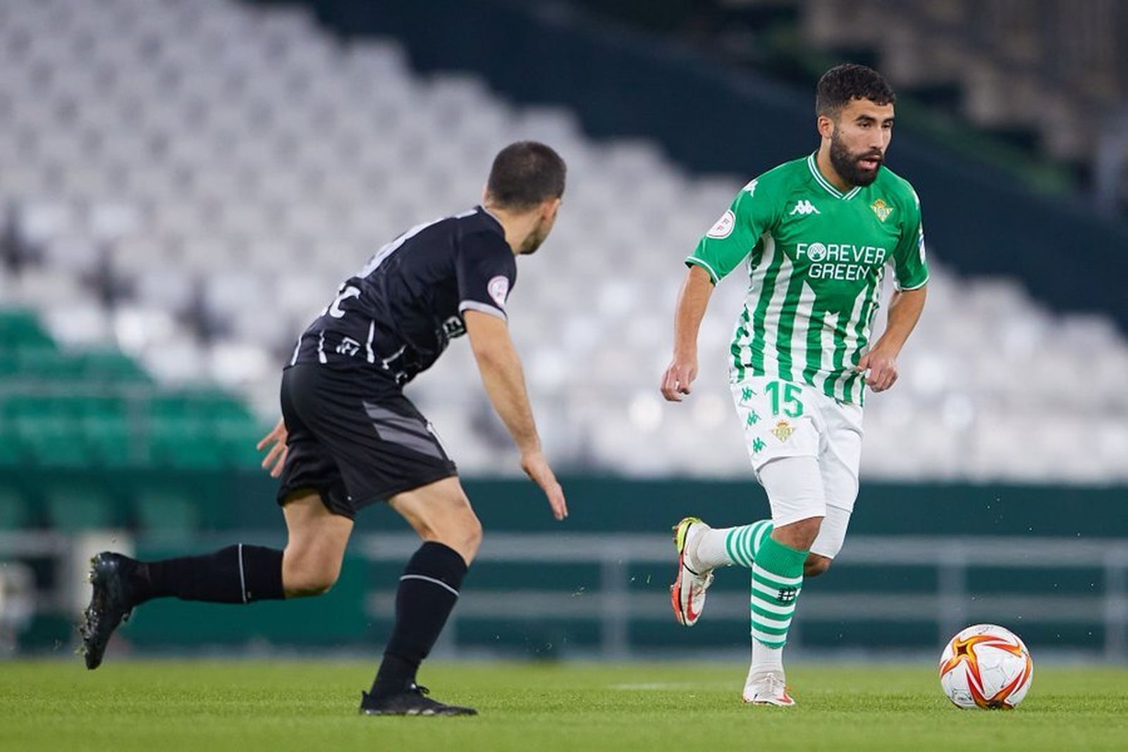 Yassin Fekir conduce el balón ante un defensor rival.